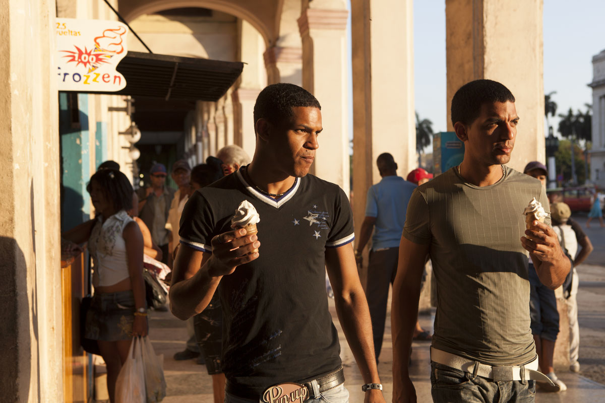 CUBA: Men eating ice-cream on Plaza Vieja, Havana